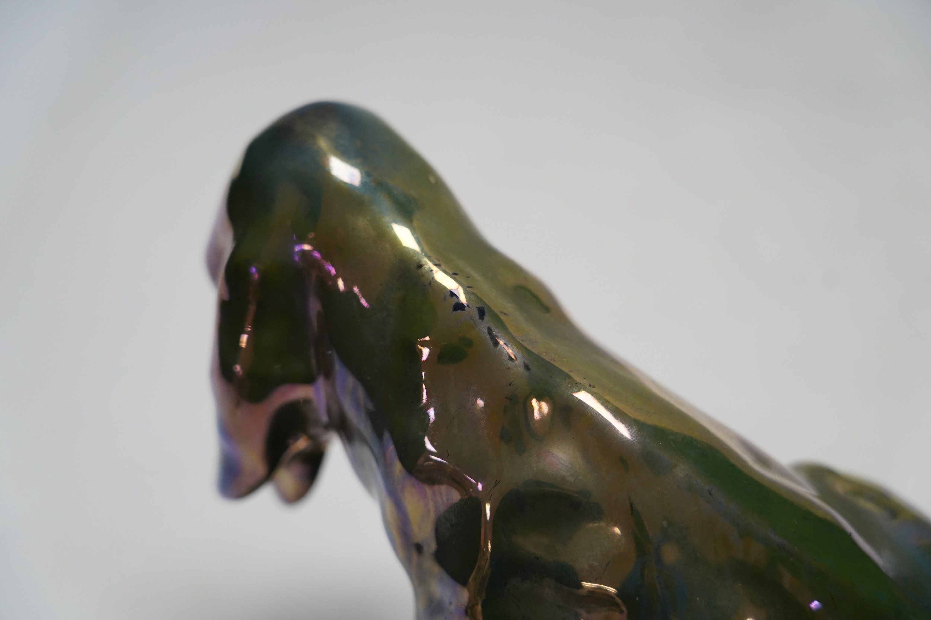 Alphonse Cytere, a French pottery lustre dog, stamped to the base, 18cm wide